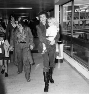 Mia Farrow at Heathrow Airport with her son Fletcher Previn. 27th September 1976 Mia Farrow at Heathrow Airport with her son Fletcher Previn. 27th September 1976