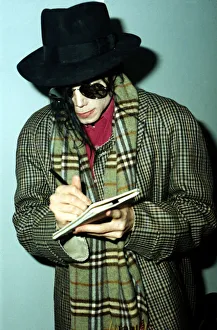 Michael Jackson signs an autograph at London airport. 7th October 1992 Michael Jackson signs an autograph at London airport. 7th October 1992