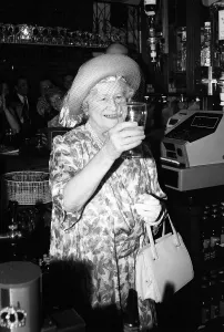 Prints of Queen Mother drinks a pint of beer in a pub in Stepney Mirror Prints: Queen Mother's Pub Visit Print (00134)