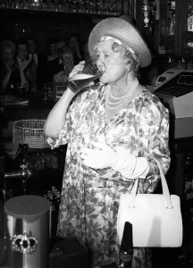 Prints of Queen Mother stands behind a pub bar drinking beer in July 1987 Mirror Prints: Queen Mother Behind the Bar Print 1987