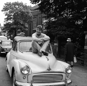Prints of Tommy Steele pictured with his Morris Minor. Yesterday he was fined £ 25 for dangerous driving on the M1 at Luton in his Jaguar. 27th August 1962 Mirror Prints: Tommy Steele with Morris Minor, 27th August 1962 Print