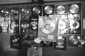 Print of Jeff Lynne with his family and gold discs, taken in 1981