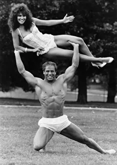 Model Linda Lusardi being lifted by nearly naked muscley strong man Julien Moss in Model Linda Lusardi being lifted by nearly naked muscley strong man Julien Moss in
