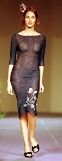 A model wearing a see through black dress October 1998 with flower pattern detail A model wearing a see through black dress October 1998 with flower pattern detail
