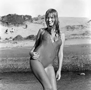 Model wearing a one piece swimsuit as she poses on a beach in Africa April 1975 Model wearing a one piece swimsuit as she poses on a beach in Africa April 1975