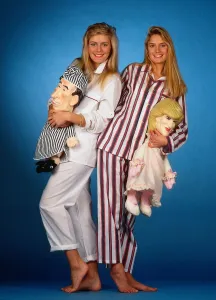Models wearing mens pyjamas holding Princess Diana and Prince Charles pyjama cases Models wearing mens pyjamas holding Princess Diana and Prince Charles pyjama cases