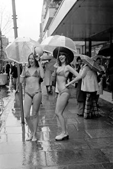 Models Wendy and Jackie seen here modeling the latest in swimwear on a wet Oxford Street Models Wendy and Jackie seen here modeling the latest in swimwear on a wet Oxford Street