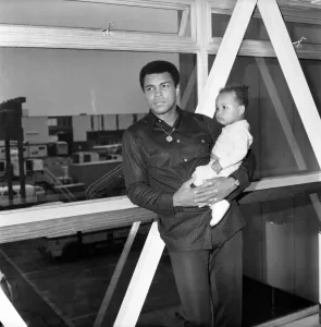 Mohammad Ali with baby Hanna at Heathrow Airport today. August 1977 77-04380-003 Mohammad Ali with baby Hanna at Heathrow Airport today. August 1977 77-04380-003