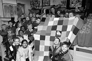 Moldgreen Junior and Infants School pulls with their knitted blanket Moldgreen Junior and Infants School pulls with their knitted blanket