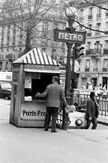 A Morning newspaper reader picks up his paper from a kiosk in the 15th district of Paris A Morning newspaper reader picks up his paper from a kiosk in the 15th district of Paris
