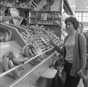 Mother and daughter buying fresh fruit from a greengrocers stall in Stafford' Mother and daughter buying fresh fruit from a greengrocers stall in Stafford'