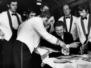Mr. J. G. Rennie, the assistant training officer, is served with a meal by trainee waiter Mr. J. G. Rennie, the assistant training officer, is served with a meal by trainee waiter