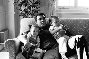 Muhammad Ali cuddling his daughters Laila, (left )and Hana (right Muhammad Ali cuddling his daughters Laila, (left )and Hana (right