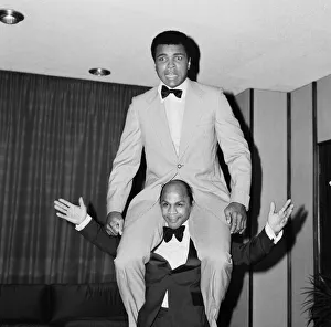 Muhammad Ali getting a piggy back from another guest at a press conference Muhammad Ali getting a piggy back from another guest at a press conference