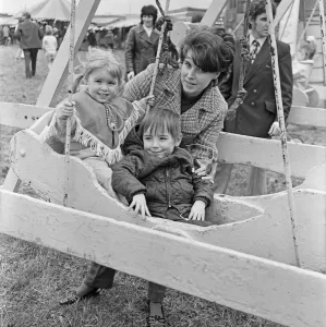 Mum with son and daughter enjoying the swings at Silcocks Fair at Skelmersdale 17th May Mum with son and daughter enjoying the swings at Silcocks Fair at Skelmersdale 17th May