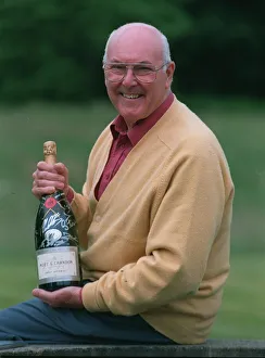 Murray Walker Motoracing Commentator July 1997 holding bottle of champagne Murray Walker Motoracing Commentator July 1997 holding bottle of champagne