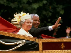 Nelson mandela waves from the carriage as he sits beside Her Majesty Queen Elizabeth II Nelson mandela waves from the carriage as he sits beside Her Majesty Queen Elizabeth II