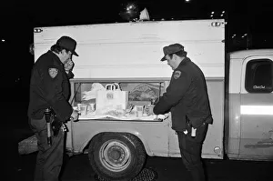 New York Police enjoying a Burger King meal from the side of a van. 13th February 1981 New York Police enjoying a Burger King meal from the side of a van. 13th February 1981