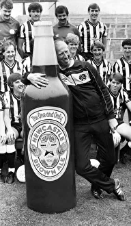 Newcastle United manager Jack Charlton clowns around with a giant bottle of Newcatle Newcastle United manager Jack Charlton clowns around with a giant bottle of Newcatle