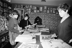 Newspaper round boys inside a newsagents, sorting the papers ready for delivery Newspaper round boys inside a newsagents, sorting the papers ready for delivery