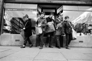 Newspaper round boys leaving the newsagents with their newspapers, ready for delivery Newspaper round boys leaving the newsagents with their newspapers, ready for delivery