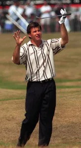 Nick Faldo Golfer holds his golf club in the air after putting his shot into a bunker Nick Faldo Golfer holds his golf club in the air after putting his shot into a bunker