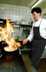 Nick Nairn chef cooking in kitchen flambe preparing starter restuarant Aberfoyle Nick Nairn chef cooking in kitchen flambe preparing starter restuarant Aberfoyle