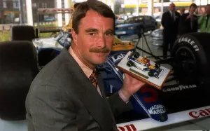 Nigel Mansell Formula One racing driver with a model of himself Nigel Mansell Formula One racing driver with a model of himself