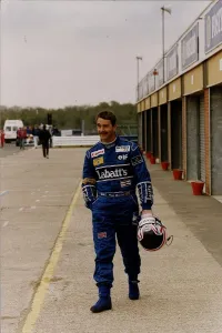 Nigel Mansell Motor Racing Grand Prix Formula One Driver walks down the pit road in his Nigel Mansell Motor Racing Grand Prix Formula One Driver walks down the pit road in his