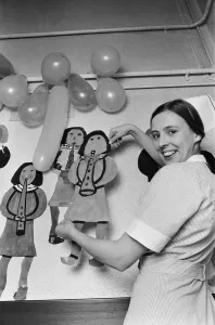 A nurse decorates a children's hospital in Birmingham. 20th December 1975 A nurse decorates a children's hospital in Birmingham. 20th December 1975
