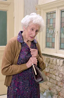 Old age Pensioners Old people OAP OAPs Old Lady holding her handbag climbing steps Old age Pensioners Old people OAP OAPs Old Lady holding her handbag climbing steps