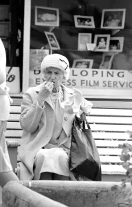 An old lady enjoying fish and chips during a day out to the beach at Trecco Bay An old lady enjoying fish and chips during a day out to the beach at Trecco Bay