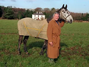 Oliver Reed actor wearing brown long coat standing in field with his horse Bobby at home Oliver Reed actor wearing brown long coat standing in field with his horse Bobby at home