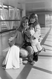 Olivia Newton John departing Heathrow Airport with her nephew Emerson. 23rd March 1979 Olivia Newton John departing Heathrow Airport with her nephew Emerson. 23rd March 1979
