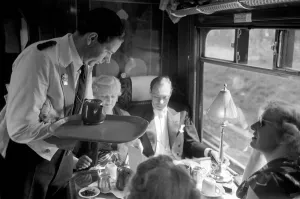 Opera goers express to Glynbourne British Rail waiter serves tea in the Buffet car Opera goers express to Glynbourne British Rail waiter serves tea in the Buffet car
