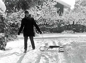 Paperboy Stephen Sales delivers his newspapers using a sledge after heavy snow in England Paperboy Stephen Sales delivers his newspapers using a sledge after heavy snow in England