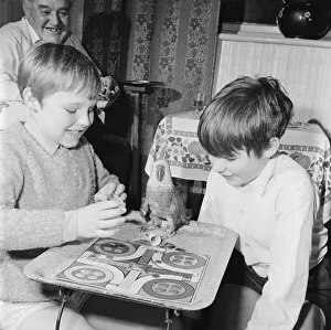 Parrot plays Ludo with two boys. Circa 1972 Parrot plays Ludo with two boys. Circa 1972
