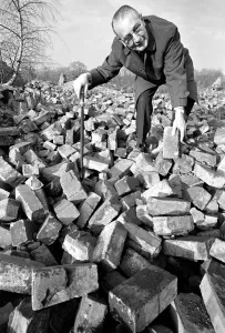 People - elderly. An old man searching through a pile of bricks. December 1969 Z11973-001 People - elderly. An old man searching through a pile of bricks. December 1969 Z11973-001