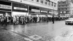 People queue around the Debenhams building in Market Street People queue around the Debenhams building in Market Street