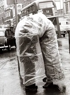 Two people sheltering from the rain - March 1970 Two people sheltering from the rain - March 1970