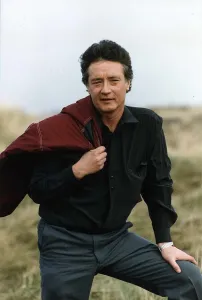Peter Caffrey Actor posing to camera fron a fiald Peter Caffrey Actor posing to camera fron a fiald