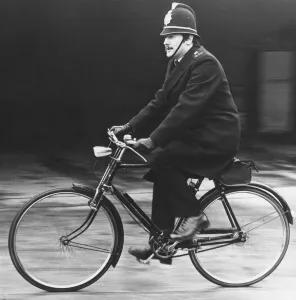 Picture shows an on duty policeman in Cambridgeshire, riding his bicycle Picture shows an on duty policeman in Cambridgeshire, riding his bicycle