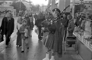 A piper plays the bagpipes dressed in full Scottish national costume including a kilt in A piper plays the bagpipes dressed in full Scottish national costume including a kilt in