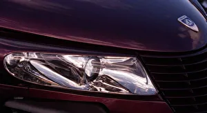 Plymouth Prowler October 1998 Detail of headlamp bonnet badge logo maroon Plymouth Prowler October 1998 Detail of headlamp bonnet badge logo maroon