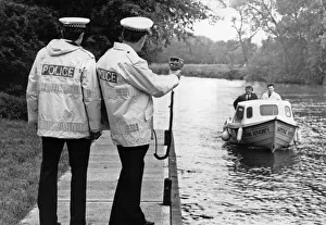 Police constable Ivan Jackson checks the speed of a passing boat along the River Cam Police constable Ivan Jackson checks the speed of a passing boat along the River Cam