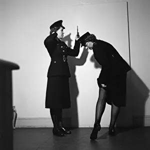 Policewomen Hilda Whitcombe (left) and Betty O'Brien trying on the new issue for Policewomen Hilda Whitcombe (left) and Betty O'Brien trying on the new issue for