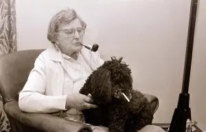 The Poodle who eats cigarettes An old lady smoking a pipe with her pet poodle who The Poodle who eats cigarettes An old lady smoking a pipe with her pet poodle who
