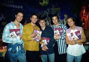 Pop group take that holding copies of their new book beore signing them for fans at Pop group take that holding copies of their new book beore signing them for fans at