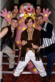Take That Pop group standing on stairs with Mr Blobby Take That Pop group standing on stairs with Mr Blobby