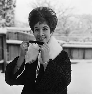 Pop singer Helen Shapiro holding a 'Nosey Cosey' Pop singer Helen Shapiro holding a 'Nosey Cosey'